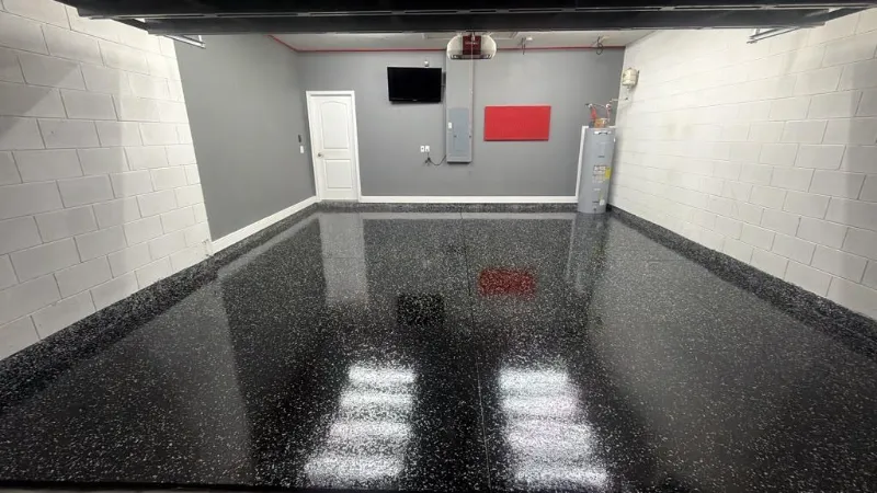 Black flake epoxy garage floor with cove base installed by Epoxy One