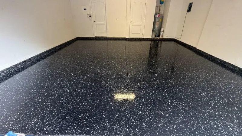 Glossy black flake epoxy garage floor installed by Epoxy One