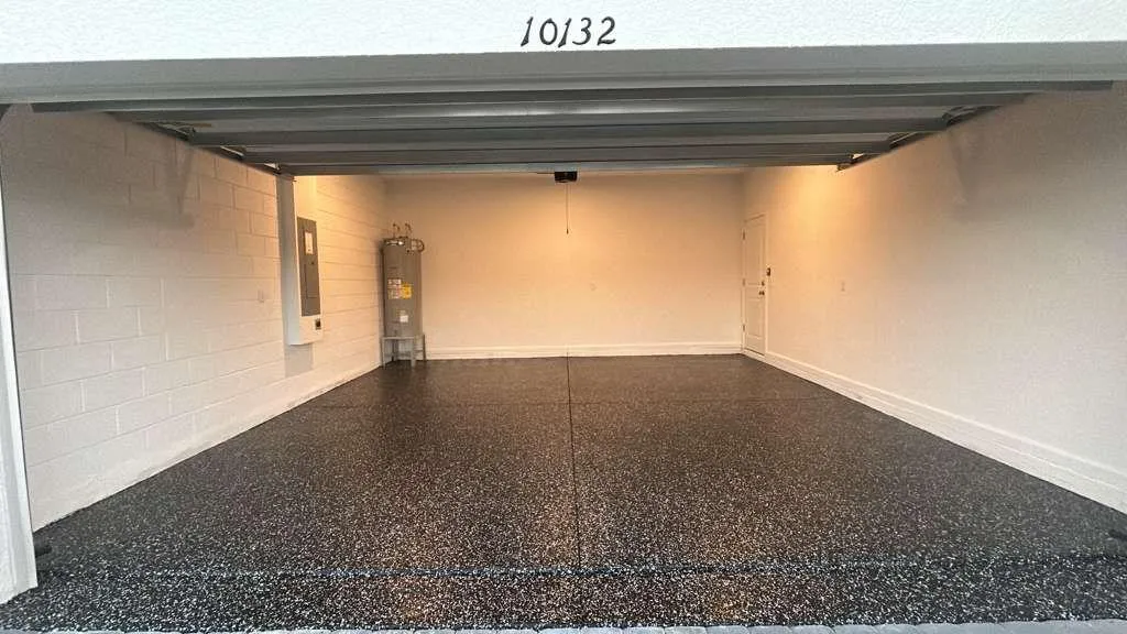 Black flake epoxy floor in a two-car garage installed by Epoxy One