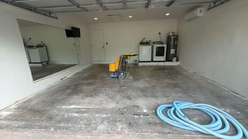 Garage concrete during diamond grinding preparation