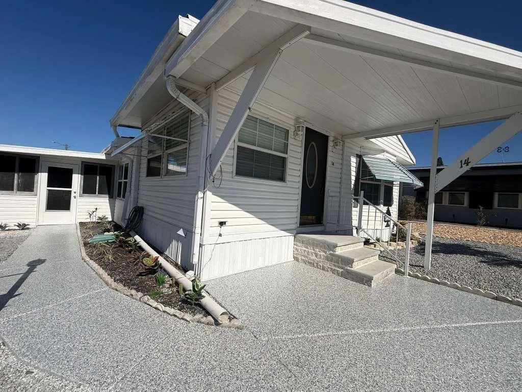 Gray flake epoxy coating on a carport and walkway installed by Epoxy One