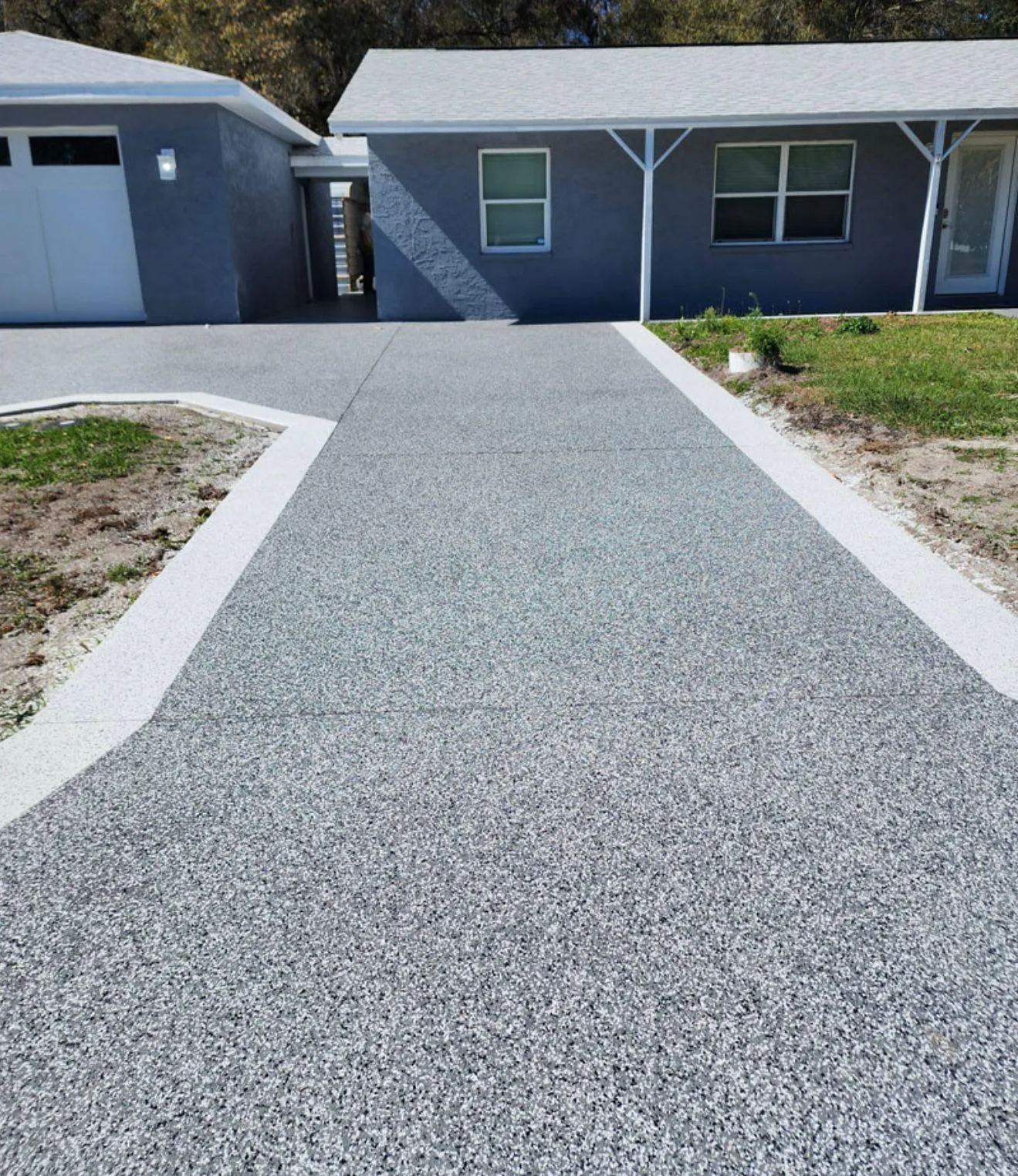 Gray flake epoxy driveway with a light flake border installed by Epoxy One