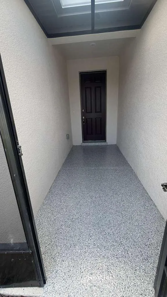 Same entryway with a gray flake epoxy floor installed by Epoxy One
