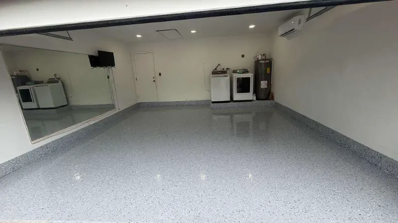 Same garage with a gray flake epoxy floor installed by Epoxy One