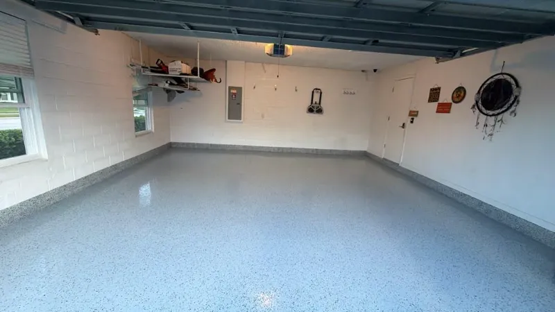 Gray flake epoxy garage with storage installed by Epoxy One